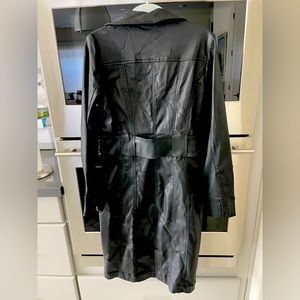 Black stretchy suede like material, a size 8 can fit into this dress, tighter